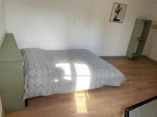 a bedroom with a bed with a comforter at Moulin de Saint-Civran in Saint-Civran