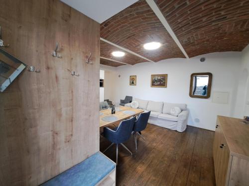 a living room with a table and a couch at Penzion U Cyrila in Moravská Třebová
