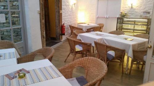 a dining room with white tables and wicker chairs at The Old Well Inn in Barnard Castle