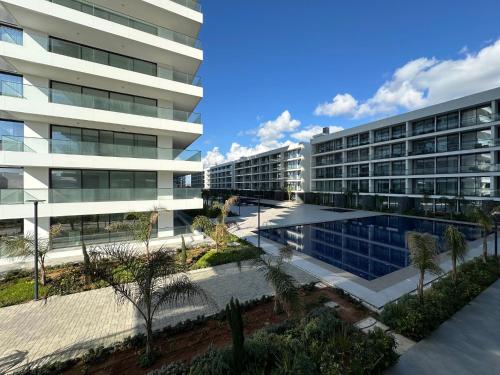 an office building with a pool in front of it at Grand Sapphire Luxury Residence By MyGuest Cyprus in Iskele