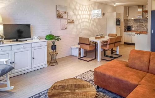a living room with a couch and a table with chairs at Vakantiewoning Bruinisse aan Jachthaven Zeeland, VP012 in Bruinisse