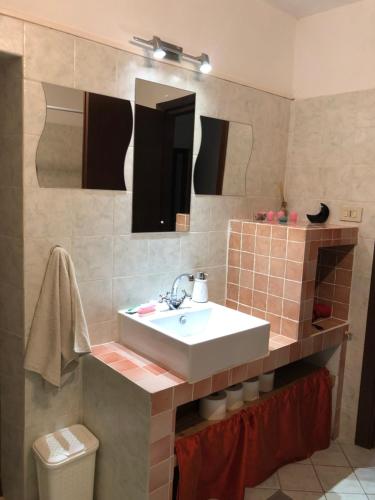 a bathroom with a sink and a mirror at Il Vicolo in Buti