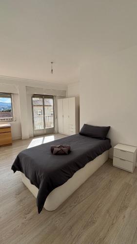 a bedroom with a large bed in a white room at Villa Artista home in Pontevedra