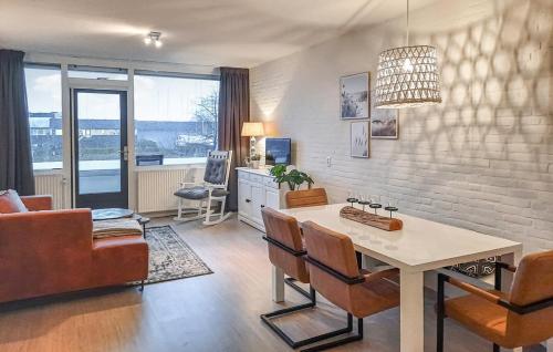 a living room with a table and chairs and a couch at Vakantiewoning Bruinisse aan Jachthaven Zeeland, VP012 in Bruinisse