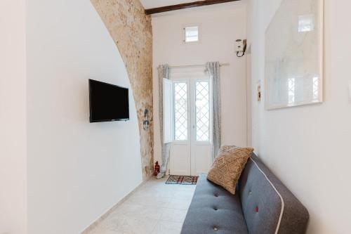 a living room with a couch and a tv at Casa Mauro e Roberta Zingaro in Castellammare del Golfo