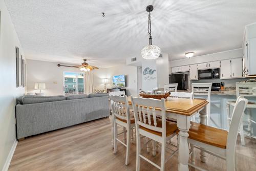 a kitchen and living room with a table and chairs at Sundial Unit D1 in Gulf Shores