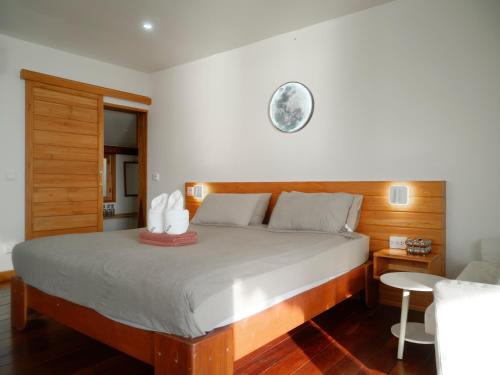 a bedroom with a bed with a clock on the wall at Tantawan sea view residence 山海居 in Salad Beach