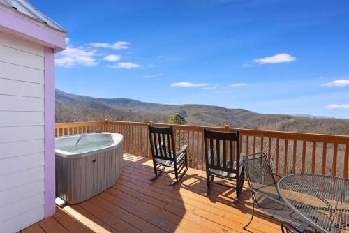 a deck with two chairs and a bath tub at Top of World in Gatlinburg