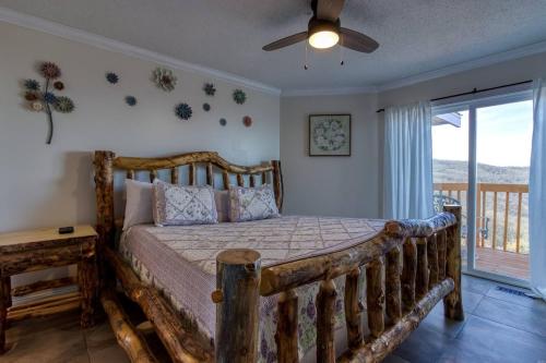 a bedroom with a wooden bed and a window at Top of World in Gatlinburg