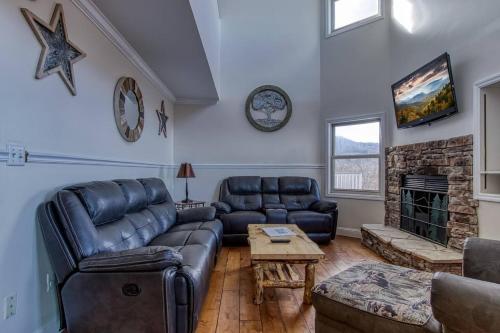 a living room with a couch and a fireplace at Top of World in Gatlinburg