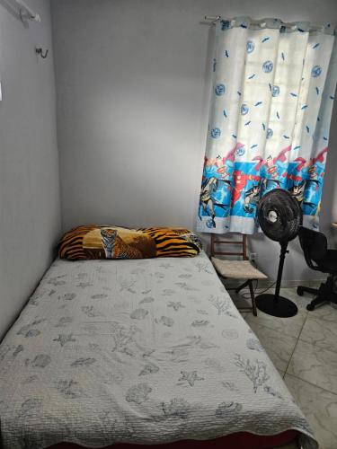 a bedroom with a bed and a window at Terraço sol e lua in Belém