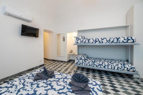 a bedroom with a bunk bed and a checkered floor at Il Pesciolino Blu Apartment in Finale Ligure