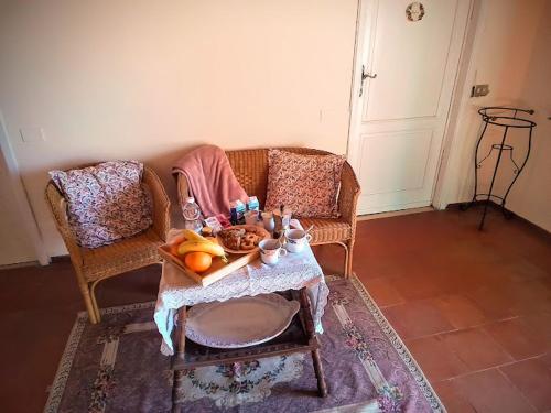 a living room with a table and two chairs at Poderino La Noce in Vinci