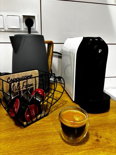 a basket of wine on a table next to a toaster at Iviskos Living Spot IΙ in Kavala