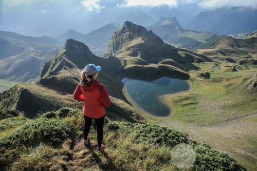 a woman standing on top of a mountain at Lou maval in Aydius