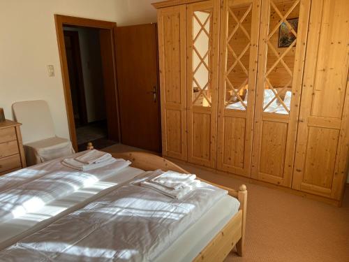 a bedroom with a bed and a wooden cabinet at Hotel Kammerhof in Mariastein