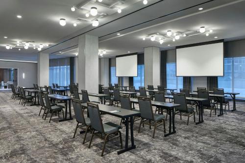 a conference room with tables and chairs and whiteboards at Hotel Celare, Cincinnati Midtown, a Tribute Portfolio Hotel in Cincinnati