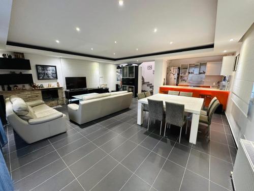 a living room with a couch and a table and chairs at Villa Eva in Mazotos