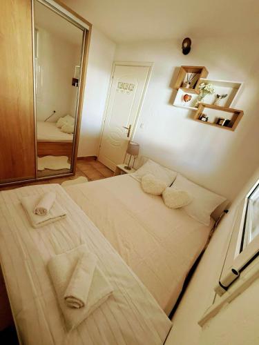 a bedroom with a large bed with towels on it at Apartment Elpida in Olympiaki Akti