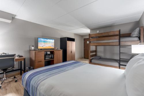 a bedroom with a bed and a flat screen tv at AmericInn by Wyndham New Richmond in New Richmond