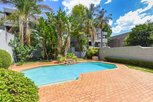 a swimming pool in the yard of a house at 3bed luxury apartment sandton city in Johannesburg