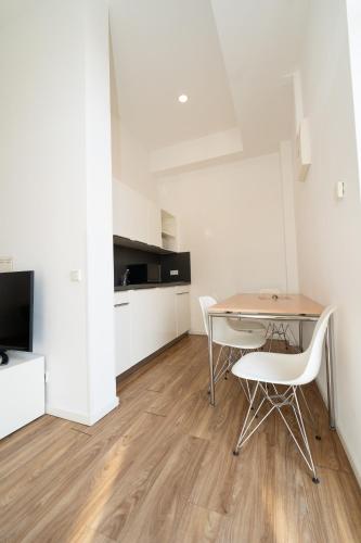 a dining room with a table and two chairs at Das Loft Apartments in Aachen