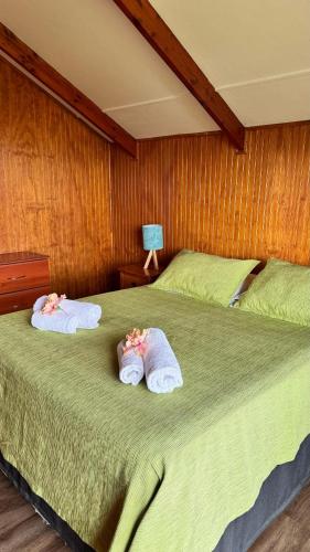 two towels on a bed in a bedroom at Cabañas Anavai Rapa Nui in Hanga Roa