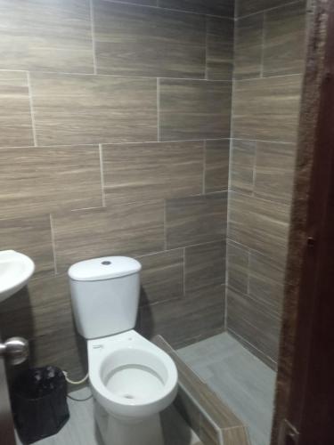 a bathroom with a white toilet and a sink at Casa Emmalana in Santa Marta