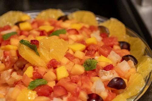 a plate of fruit salad with oranges and other vegetables at Villa Park Hotel in Natal