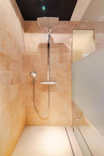 a shower with a shower head in a bathroom at Stilhaus 1730 in Königsbach Stein