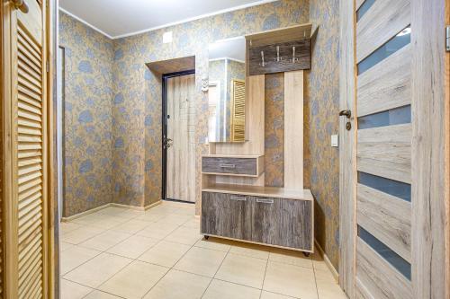 a bathroom with a sink and a wooden door at Svencelės butas in Svencelė