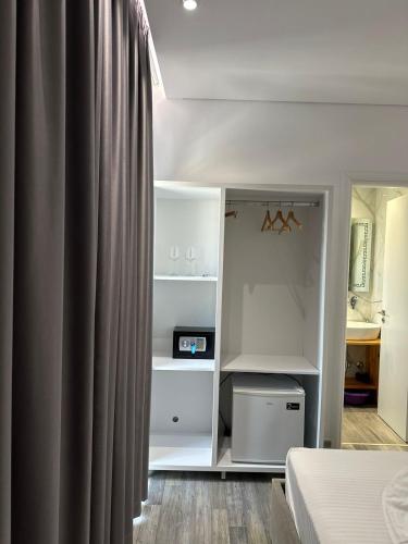 a bedroom with a bed and a curtain at Luxury Villa Alisja Sarande with Private Beach in Sarandë