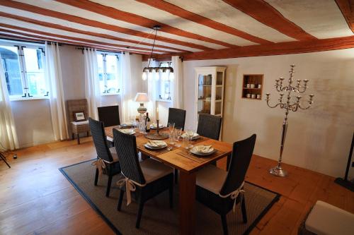 a dining room with a wooden table and chairs at RefuKium alte Kutscherei in Weißenburg in Bayern