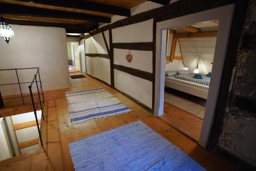 a room with a bed and two rugs on the floor at RefuKium alte Kutscherei in Weißenburg in Bayern