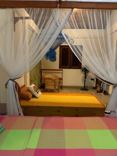 a bedroom with a bed with white drapes at Victoria House by Srilanka Tripper in Kandy