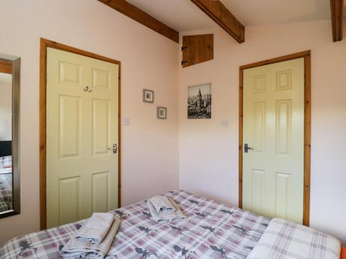 a bedroom with two doors and a bed at The Nook in Swindon
