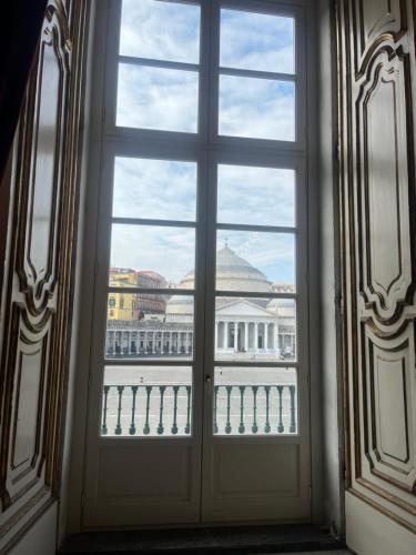 a window with a view of a building at Casetta Piazza Plebiscito in Naples