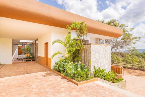 an exterior view of a house with plants at Amaya Kampot Homestays in Kampot