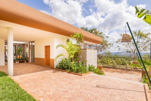 an exterior view of a house with a brick driveway at Amaya Kampot Homestays in Kampot