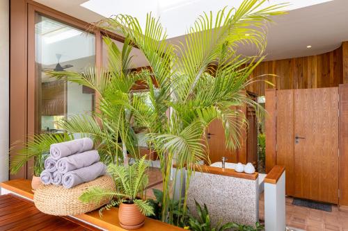 a bathroom with a bunch of towels and palm trees at Amaya Kampot Homestays in Kampot
