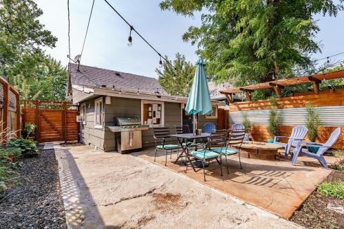 a patio with a table and chairs and an umbrella at #StayInMyDistrict Hyde Park Studio Up in Boise