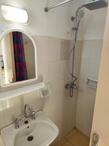 a bathroom with a sink and a shower at YANNA Studios & Apartments in Tsilivi