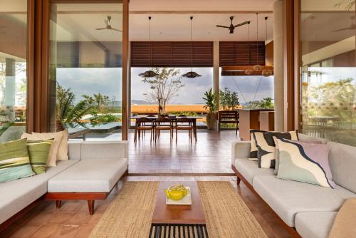 a living room with a couch and a table at Amaya Kampot Homestays in Kampot