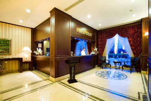 a hotel lobby with a bar and a salon at Latanya Palm Hotel Antalya in Antalya