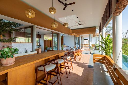 an outdoor bar with chairs and tables and windows at Amaya Kampot Homestays in Kampot