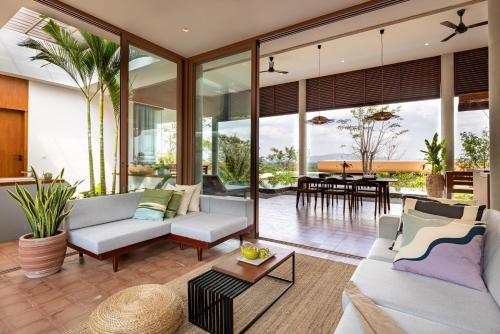 an open living room with sliding glass doors at Amaya Kampot Homestays in Kampot