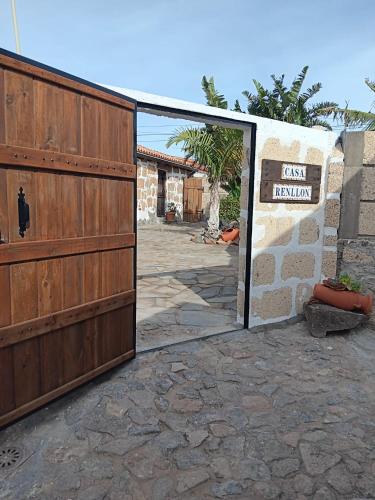 an entrance to a house with a wooden gate at Renllon in Lomo de Arico