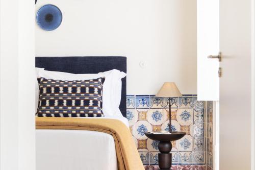 a bedroom with a bed with a pillow on it at Ando Living - Santa Justa 79 House in Lisbon
