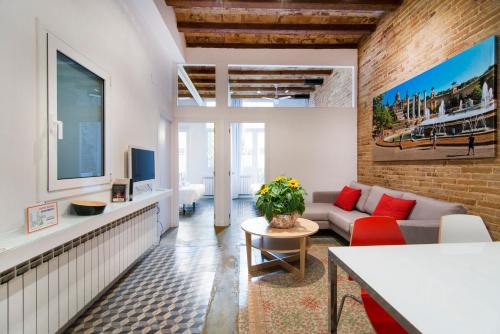 a living room with a couch and a table at Happy People Plaza España Apartments in Barcelona
