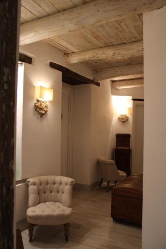 a living room with a chair and a couch at La Casa della Filanda in Belmonte Calabro